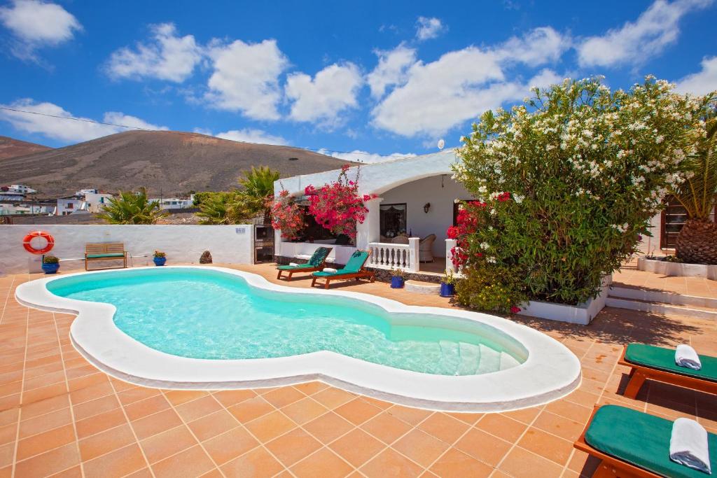 a swimming pool in a yard with a house at Villa Dune in La Asomada
