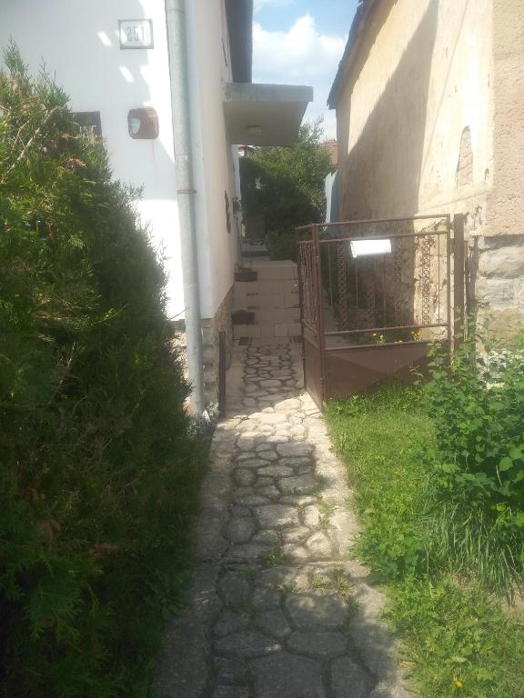 a path leading to a house with a gate at Privát u Ivana in Štrba