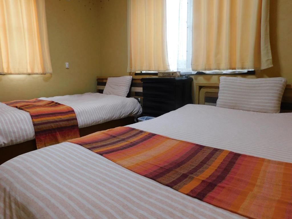 Postel nebo postele na pokoji v ubytování Guesthouse Shang