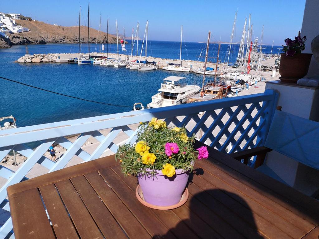 a pot of flowers on a balcony with a marina at Glaros in Pera Gyalos