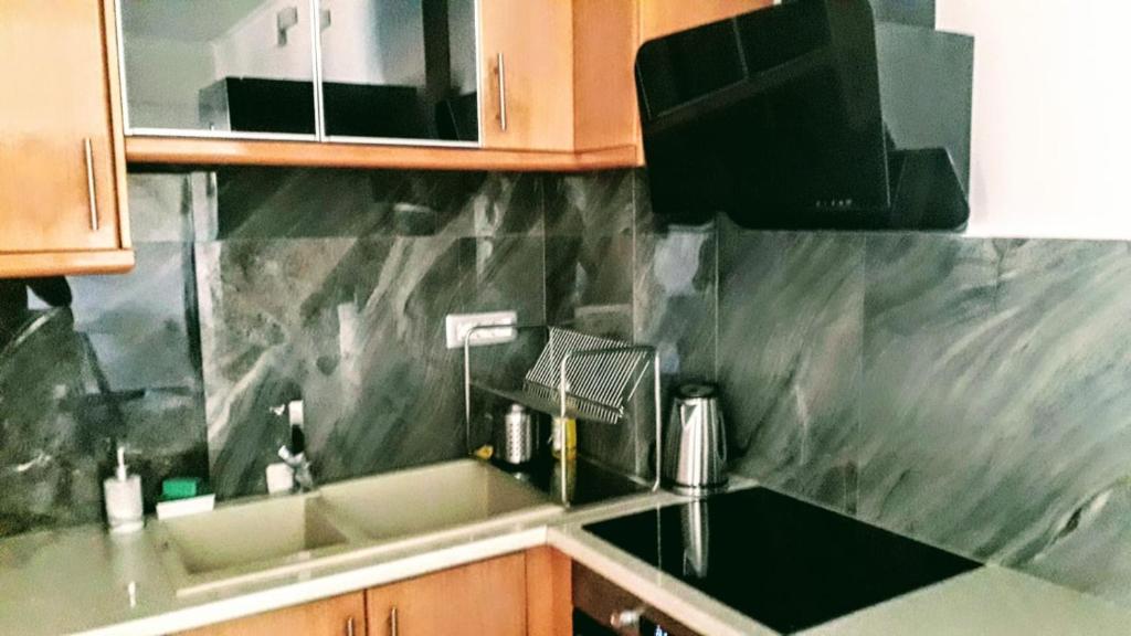 a kitchen with a sink and a counter top at Tony Central Luxury Apartment 1 in Chania Town