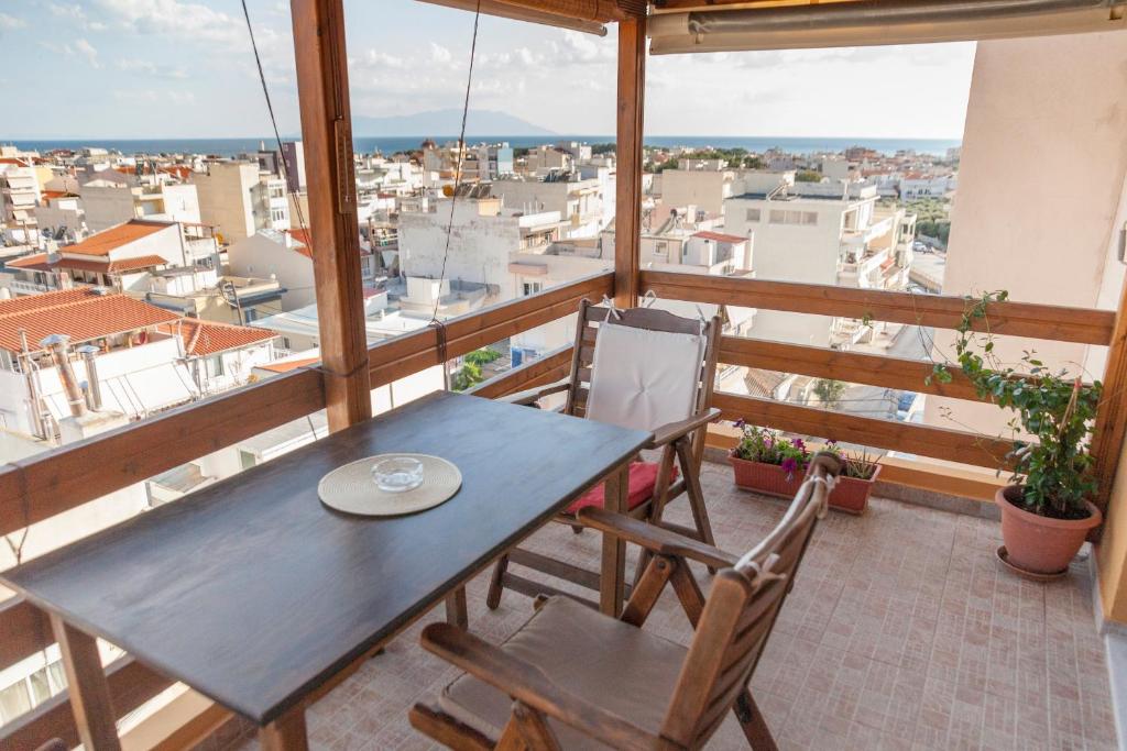 a table and chairs on a balcony with a view at Attic Anemoessa in Alexandroupoli