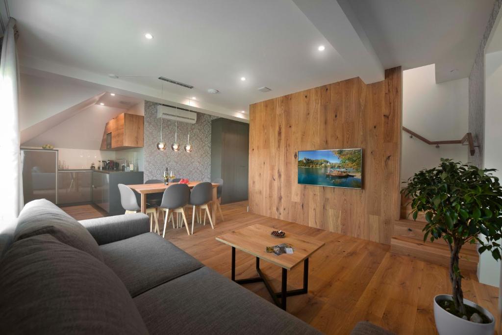 a living room with a couch and a table at Vila Ula La Luxury Apartments in Bled