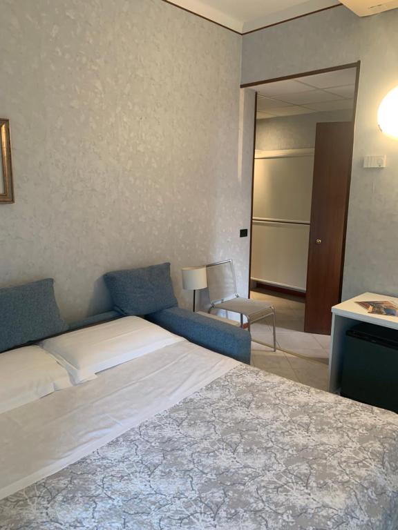 Postel nebo postele na pokoji v ubytování Hotel Residence Mondial