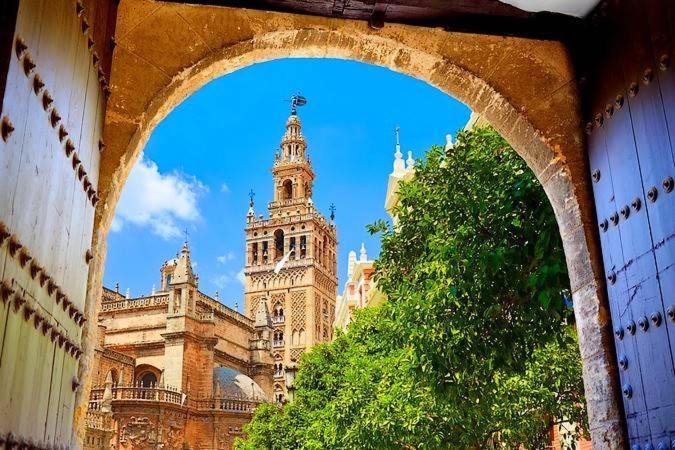 a large building with a clock tower on top of it at Hub Hostel Seville in Seville