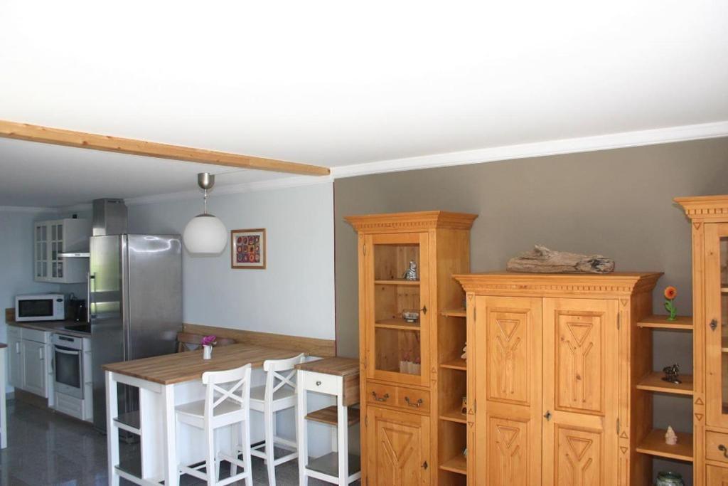 a kitchen with a table and some wooden cabinets at Quartier78 in Mittweida