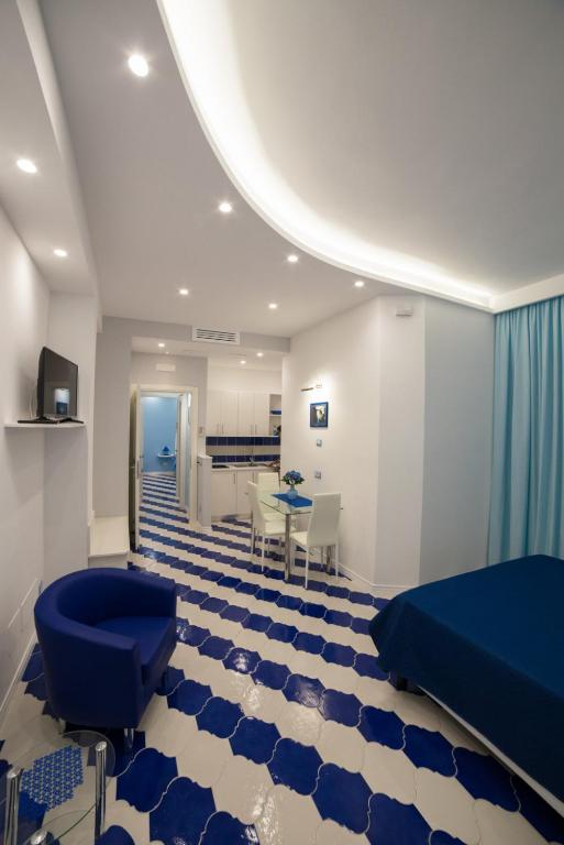 a hospital room with a blue bed and a table at Marilisa Holidays in Maiori