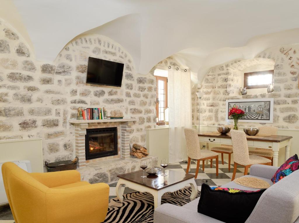 a living room with a stone wall at Apartments Zebra in Tivat