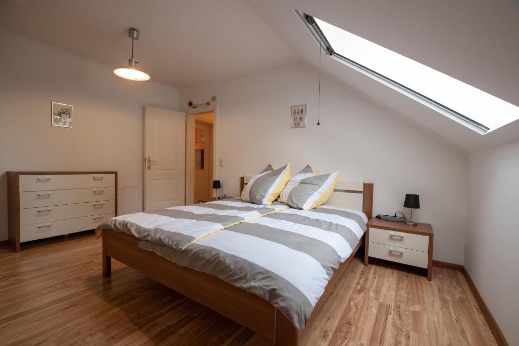 a bedroom with a large bed and a skylight at Ferienwohnung Michael in Aigen im Ennstal