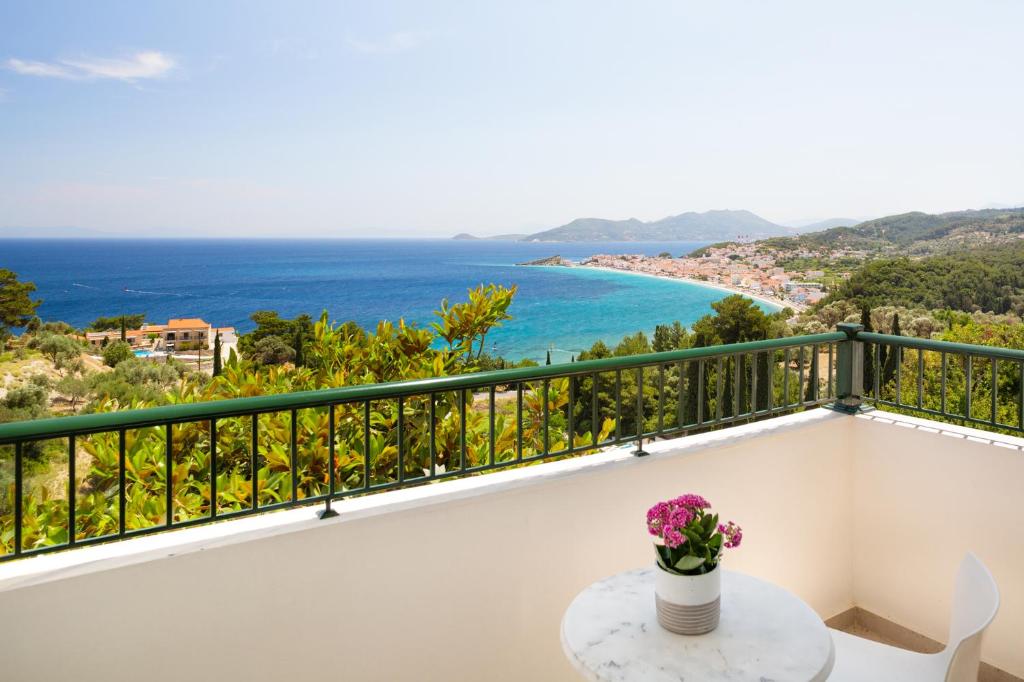 a balcony with a table and a view of the ocean at Kalidon Panorama Hotel in Kokkari