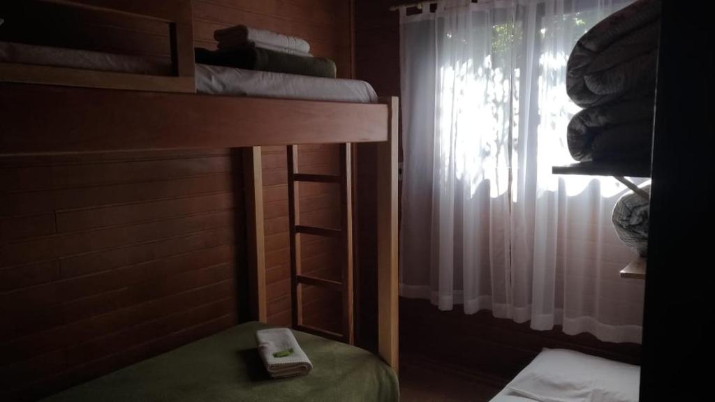 Postel nebo postele na pokoji v ubytování Chalés Araucárias da Serra