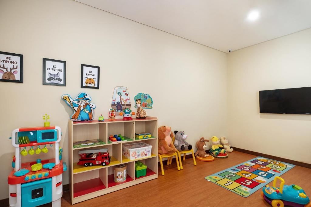a room with a tv and toys in it at Anja Jimbaran in Jimbaran