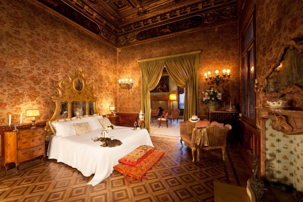 a bedroom with a bed with a cat laying on it at Palazzetto Pisani Grand Canal in Venice