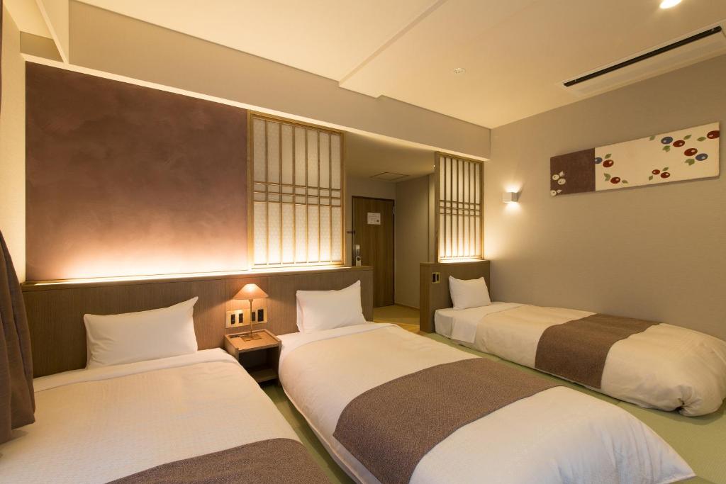 Postel nebo postele na pokoji v ubytování Matsue New Urban Hotel