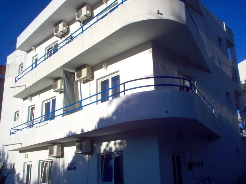a white building with balconies on the side of it at Apartments Jadran in Herceg-Novi