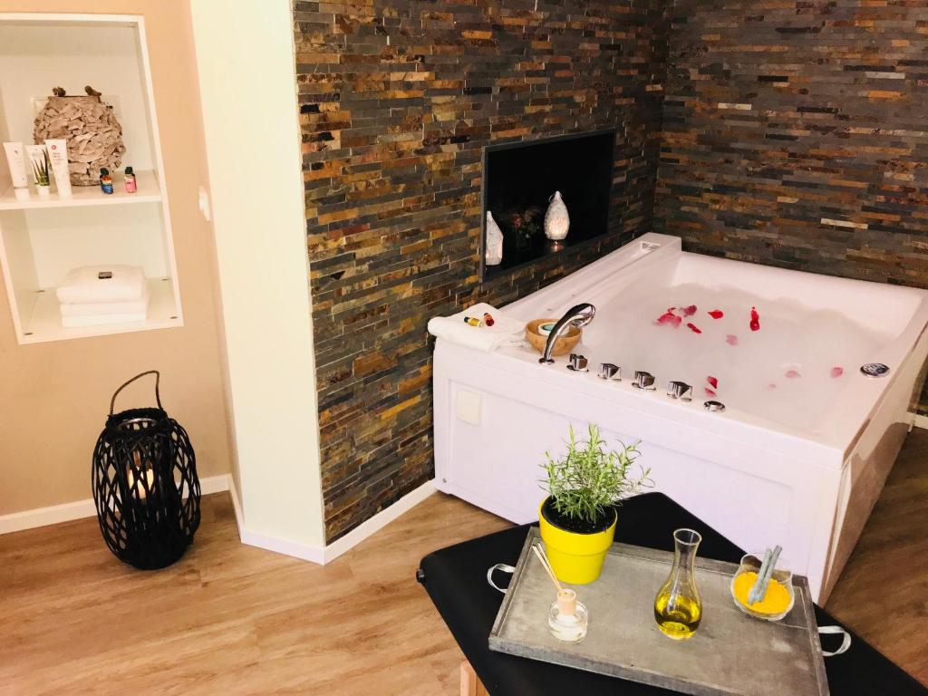 a bath tub with red paint on a brick wall at VILLA RELAX in Gerolstein