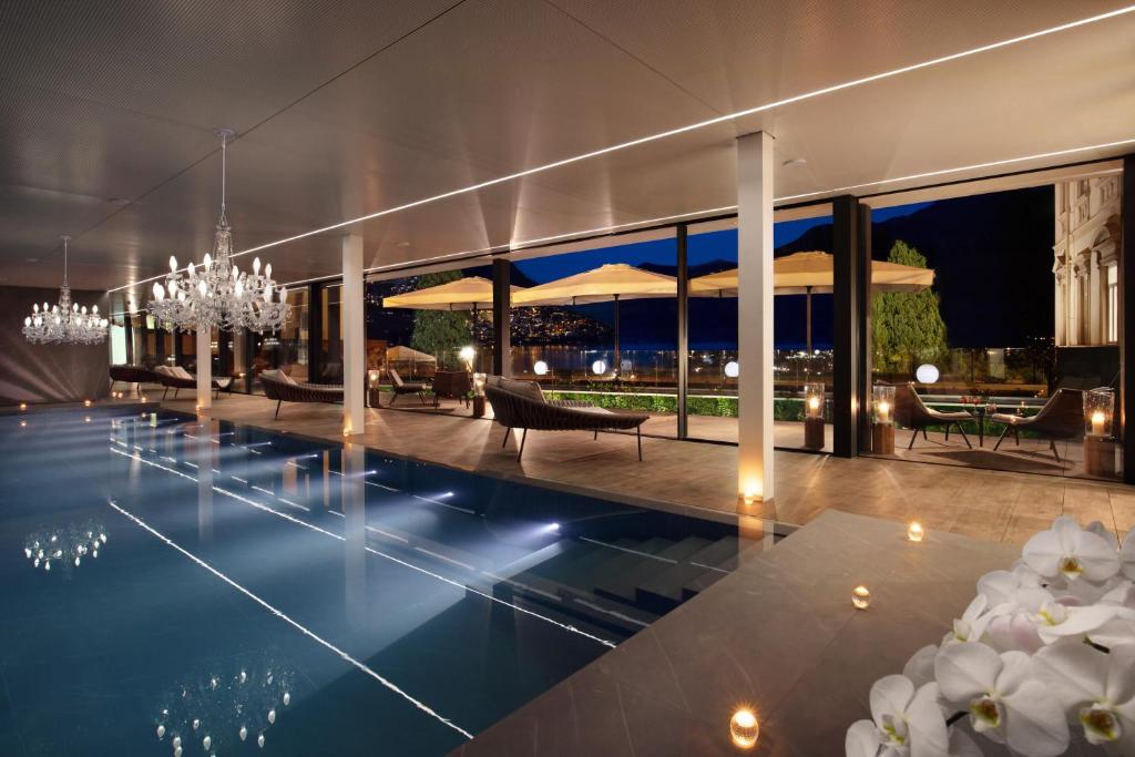 a villa with a swimming pool at night at Hotel Splendide Royal in Lugano