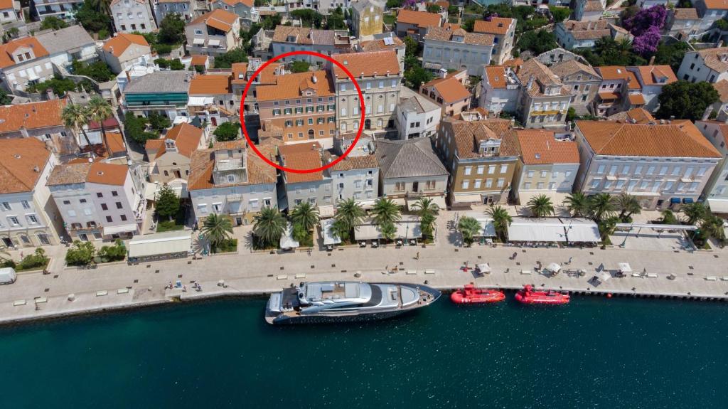 a boat in the water in front of a city at House Catania in Mali Lošinj