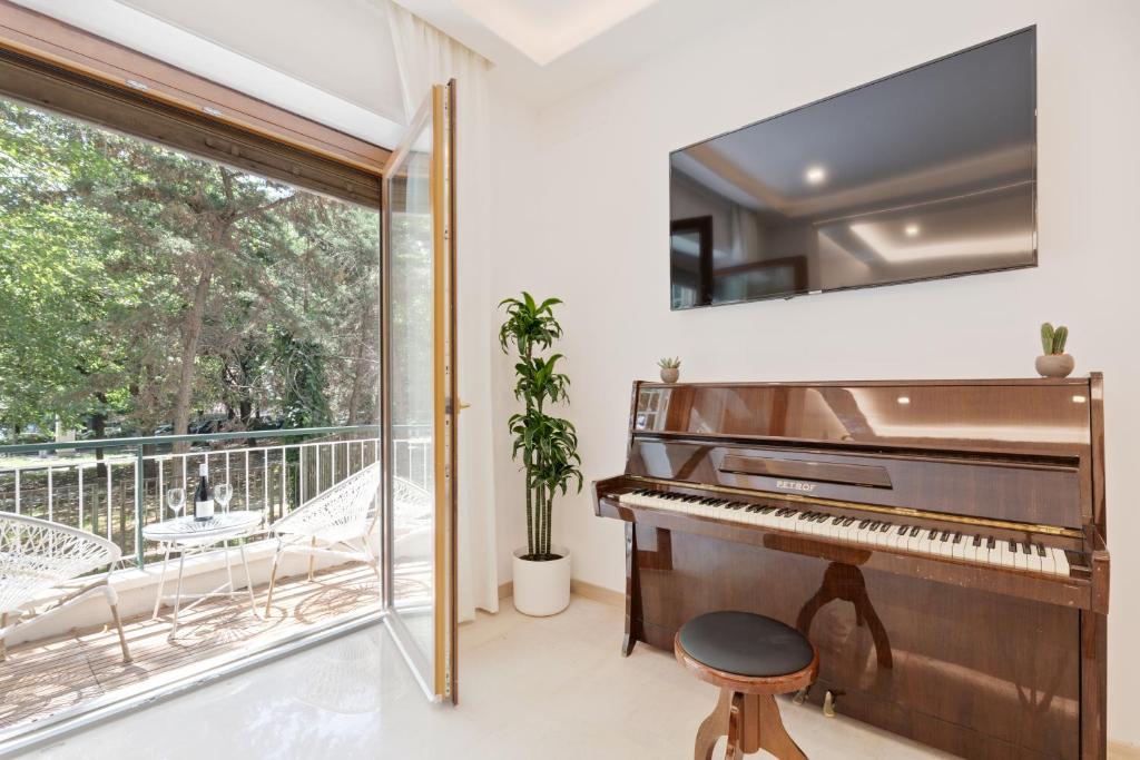 a piano in a room with a balcony at First Class Rome Apartments in Rome