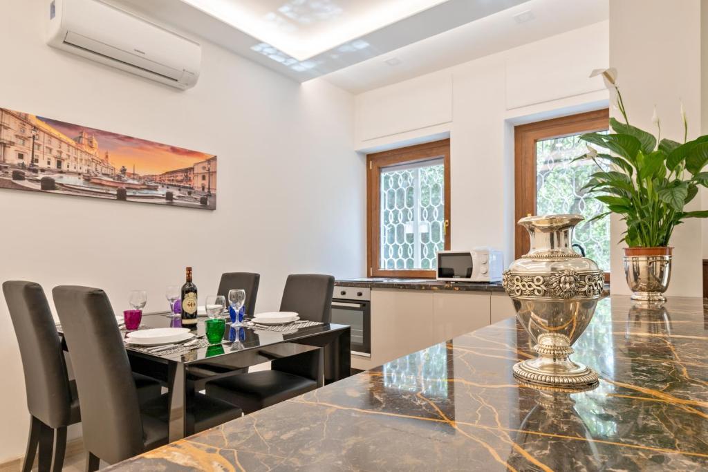 a dining room with a table and chairs at First Class Rome Apartments in Rome