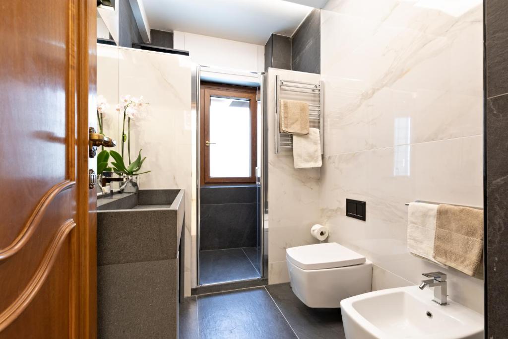 a bathroom with a toilet sink and a shower at First Class Rome Apartments in Rome