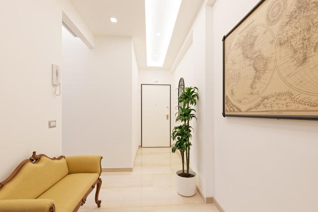 a living room with a couch and a map on the wall at First Class Rome Apartments in Rome