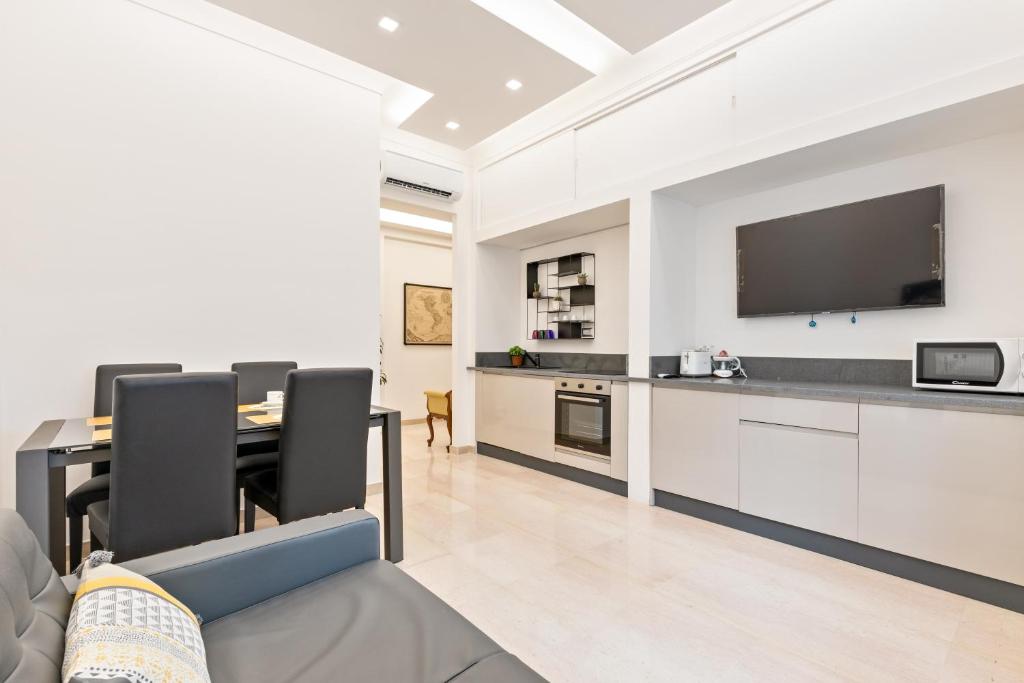 a living room with a table and a tv on a wall at First Class Rome Apartments in Rome