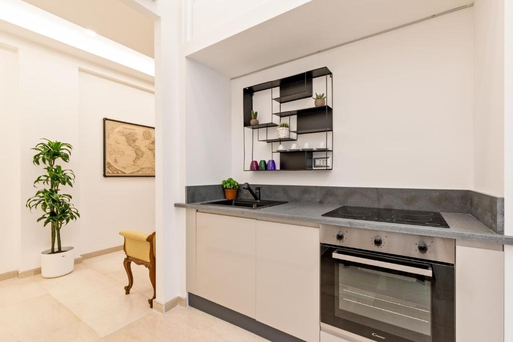a kitchen with white cabinets and a counter top at First Class Rome Apartments in Rome