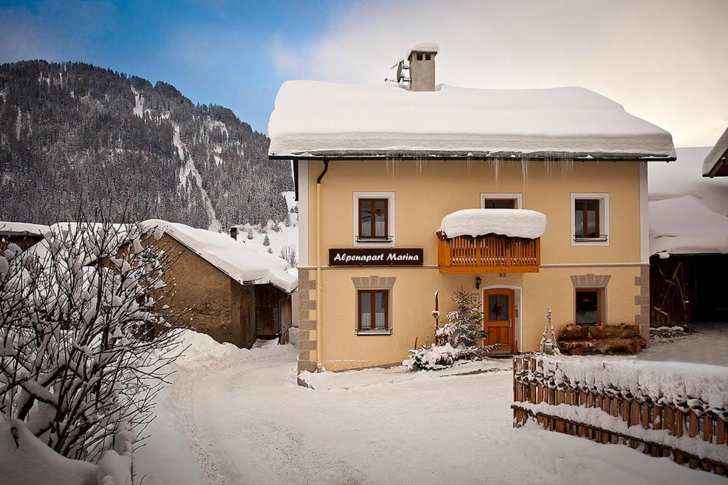 a house with snow on the top of it at Alpenapart Marina in Nauders