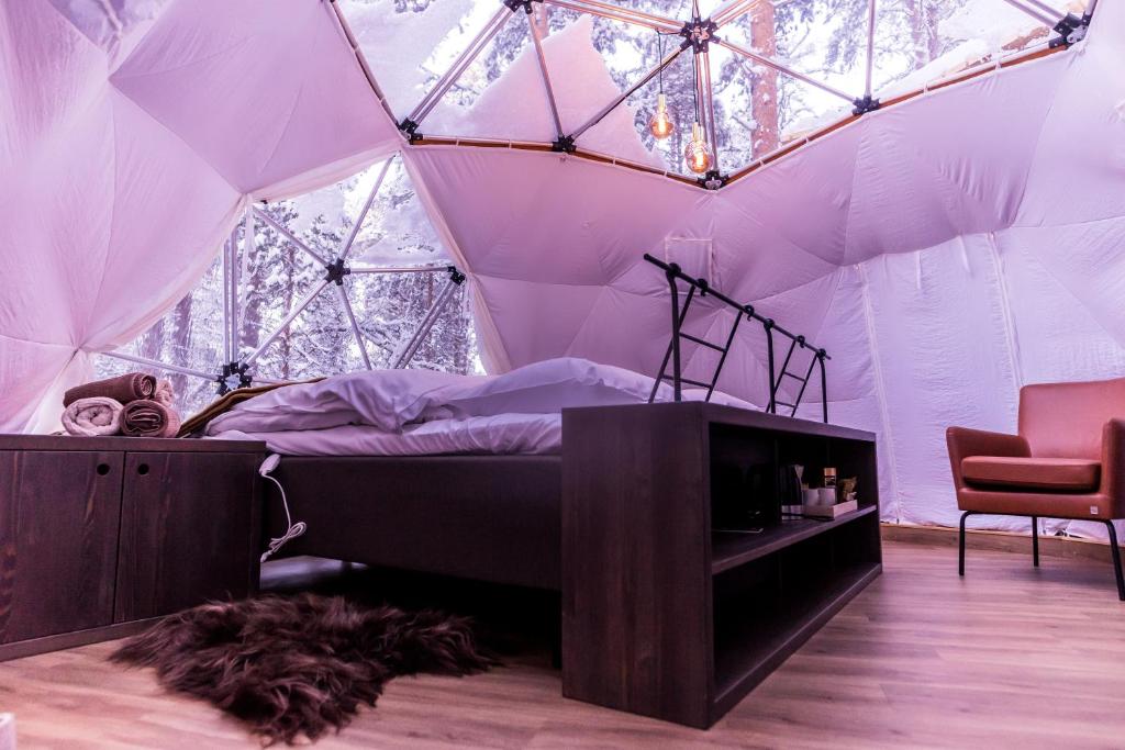 a bedroom with a bed in a tent at GLØD Aurora Canvas Dome in Alta