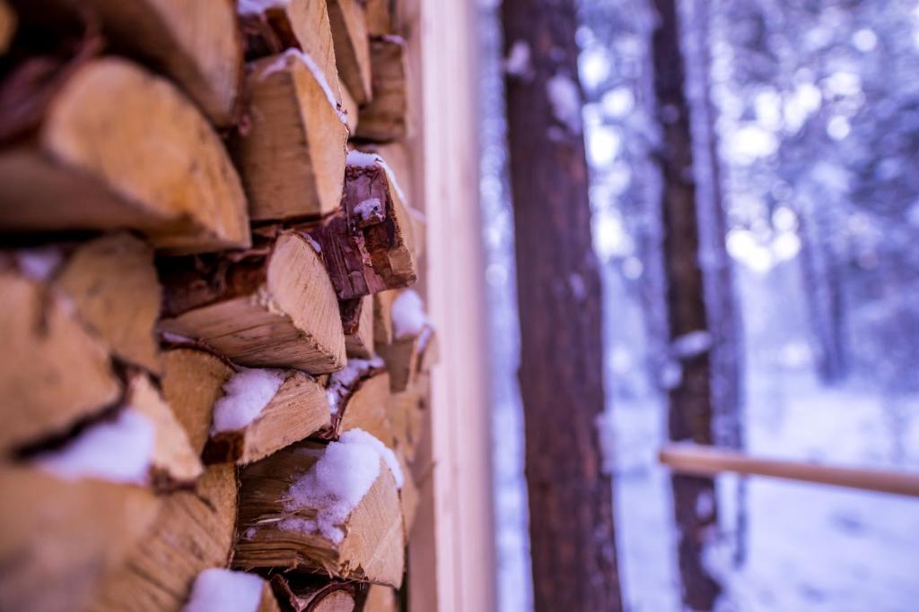 a brick wall with snow on the side of it at GLØD Aurora Canvas Dome in Alta