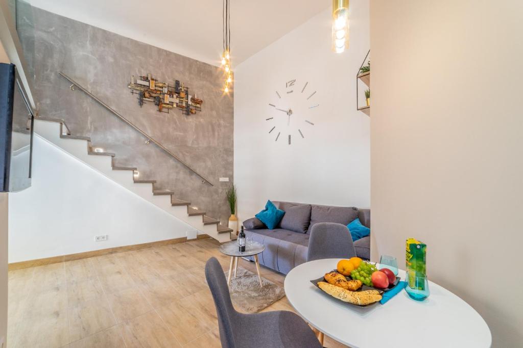 a living room with a table with fruit on it at Paulay Boutique Residences Downtown in Budapest