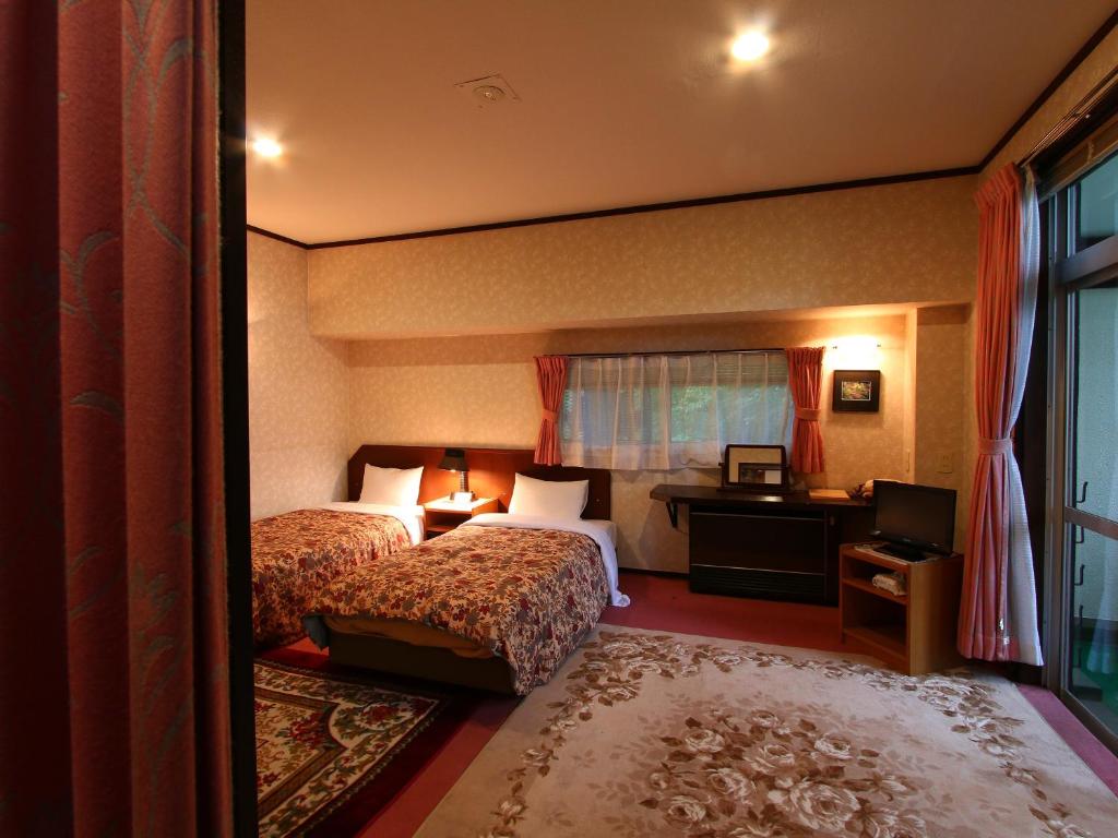 Postel nebo postele na pokoji v ubytování Hotel Mumon