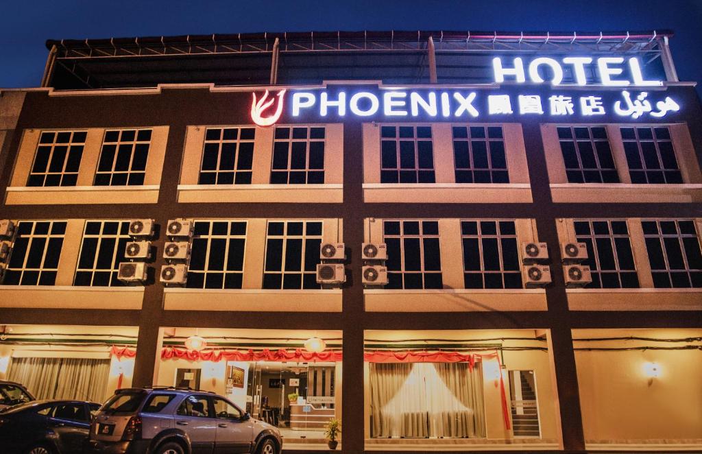 a hotel with a sign on the front of it at Phoenix Hotel in Gua Musang