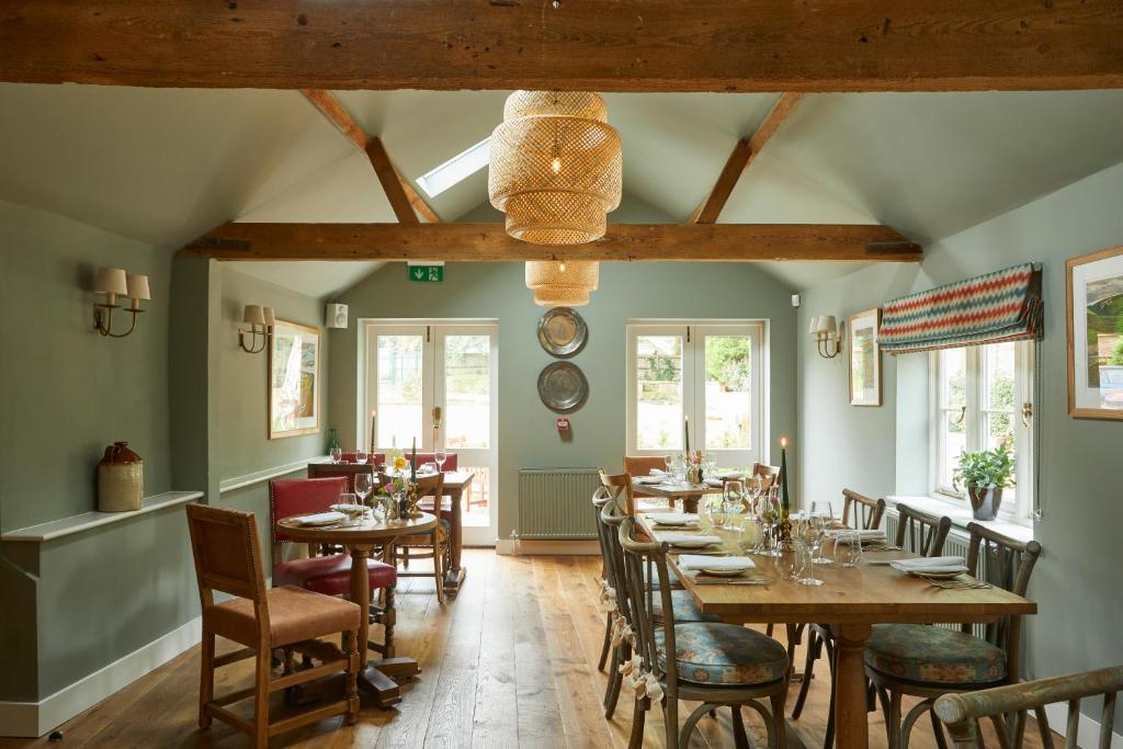 a dining room with wooden tables and chairs at Crown and Anchor in Marlborough
