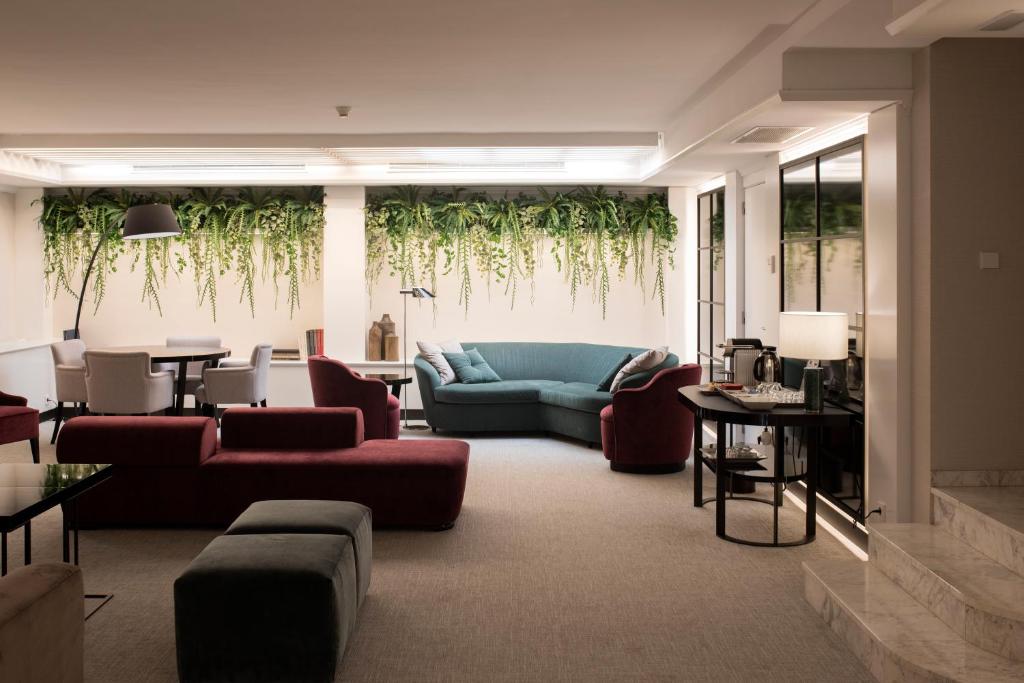a living room with a couch and chairs and a table at Acacia Suite in Barcelona