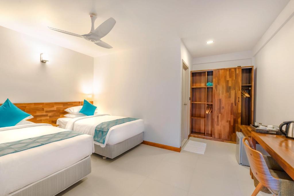 Postel nebo postele na pokoji v ubytování Ithaa Dhigurah Maldives