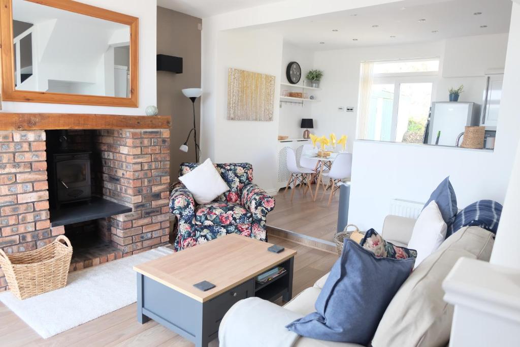 a living room with a couch and a fireplace at 1 Saron Cottages in Llandudno