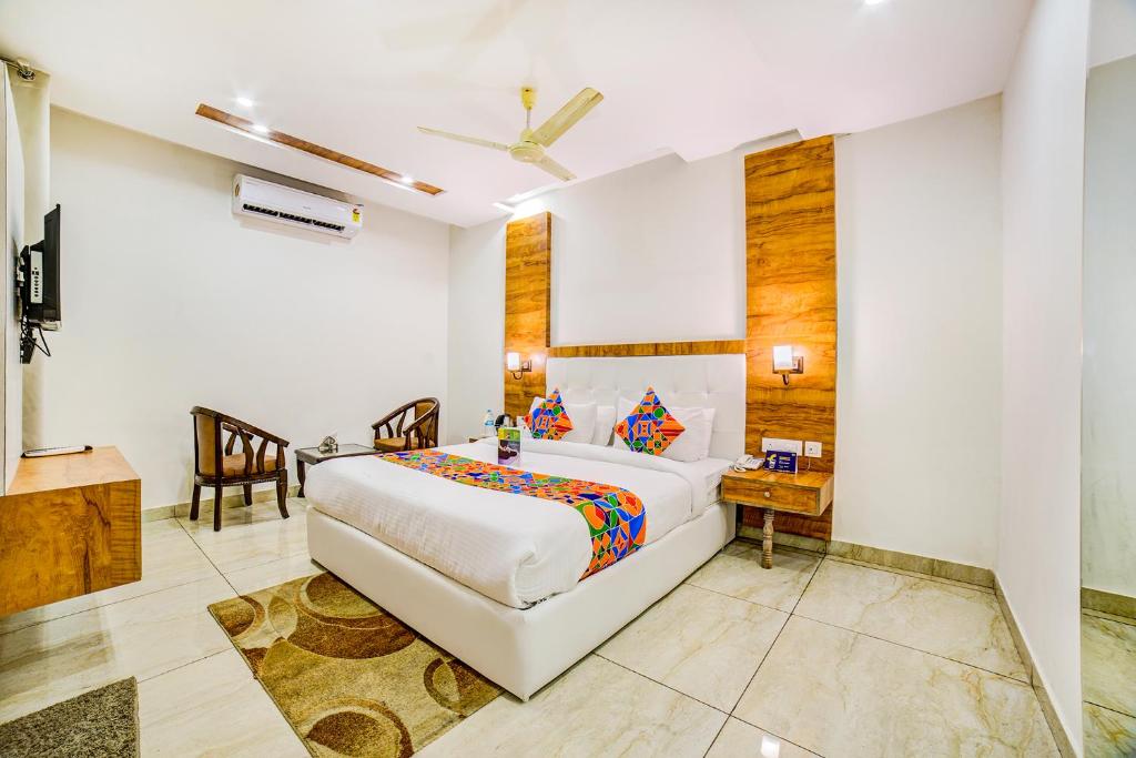 a bedroom with a bed and a desk in a room at Hotel Destination in Chandīgarh
