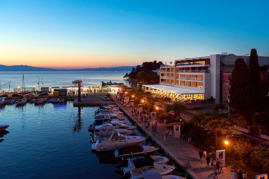 a group of boats parked in a marina at night at Luxury Hotel Riva in Malinska