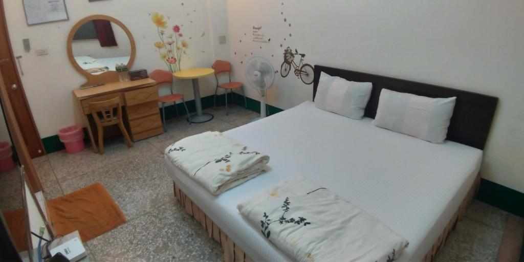 Postel nebo postele na pokoji v ubytování Sun Wu Homestay