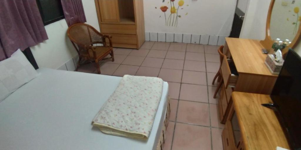 Postel nebo postele na pokoji v ubytování Sun Wu Homestay