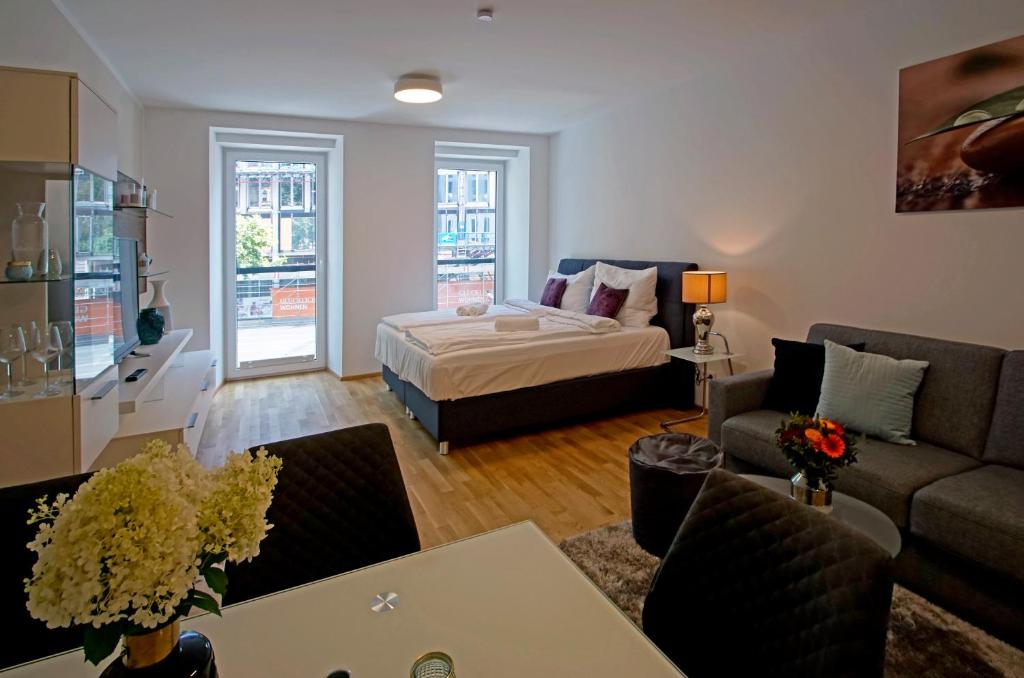 a living room with a bed and a couch at English Theater Apartment at Rathaus in Vienna