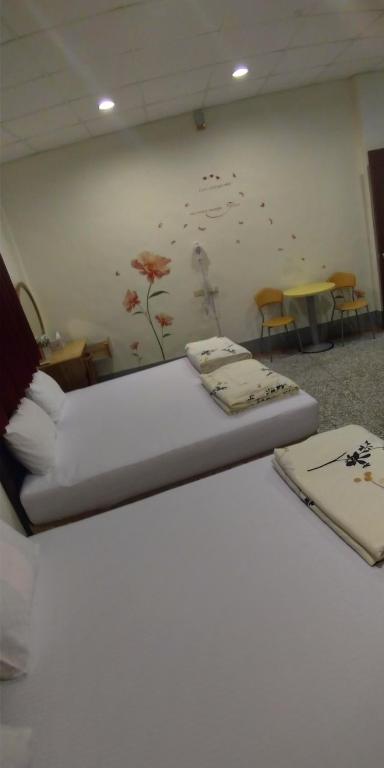 Postel nebo postele na pokoji v ubytování Sun Wu Homestay