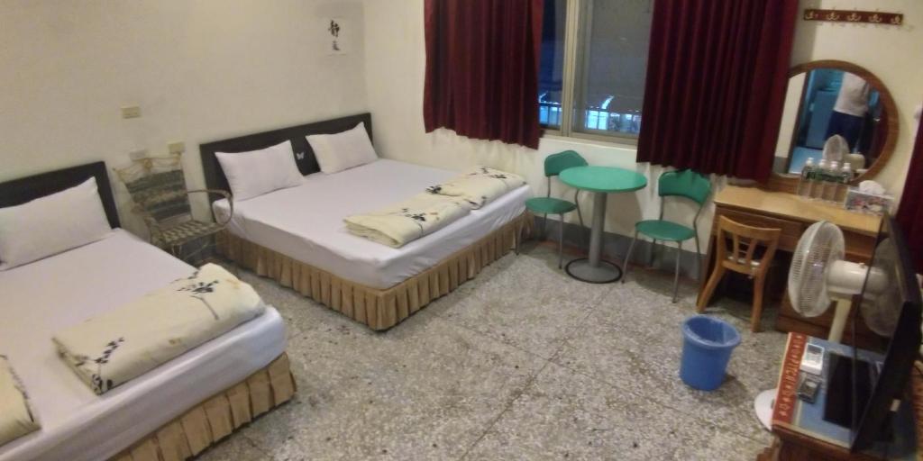 Postel nebo postele na pokoji v ubytování Sun Wu Homestay