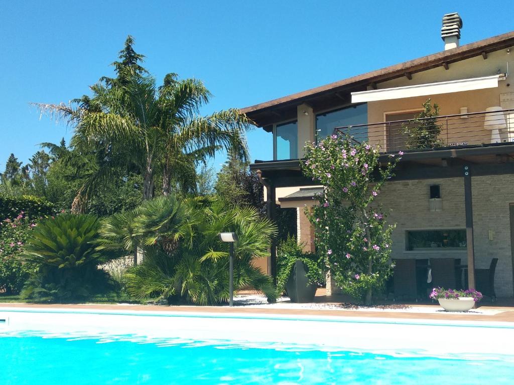 a house with a swimming pool in front of it at B&B Valleluna in Trani