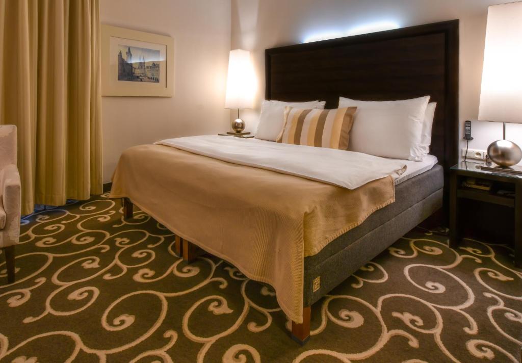 Postel nebo postele na pokoji v ubytování Grand Hotel Bohemia