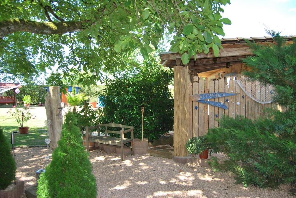 a garden with a wooden fence and a bench at Ferienappartement Pirmasens in Pirmasens