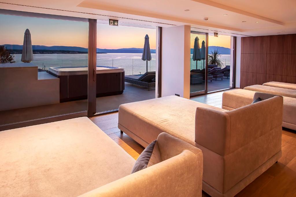 a living room with a view of the ocean at Luxury Hotel Riva in Malinska