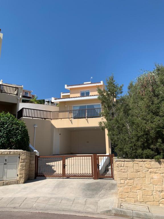 a large house with a balcony and a driveway at Melanos Village C1 in Chlorakas